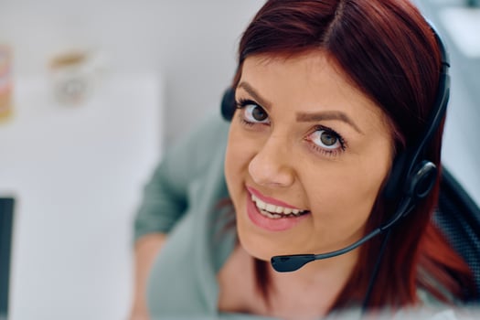 Friendly Call Center Agent Answering Incoming Calls with Headset Providing Remote Customer Service. photo