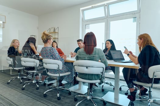 Diverse Business Team Discussing Projects in a Modern Glass Office. photo