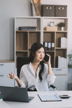 Attractive asian woman using a laptop PC and a smart phone. photo