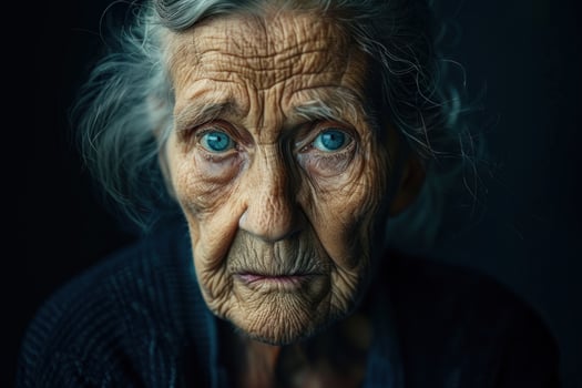 Close-up portrait of a senior woman with deep blue eyes and detailed wrinkles photo