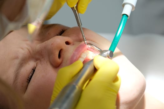 Dentist's hands giving anesthetic injection to female patient during dental procedure in clinic. Doctor making anesthetic injection to woman in dentistry office. Dental treatment concept. Close-up. photo