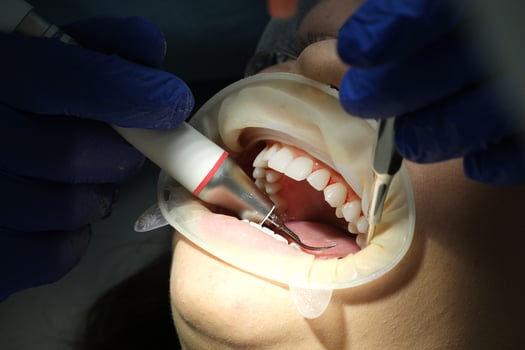 Dentist's hands giving anesthetic injection to female patient during dental procedure in clinic. Doctor making anesthetic injection to woman in dentistry office. Dental treatment concept. Close-up. photo