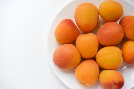 Yellow plums on a white plate. Fresh fruits. photo