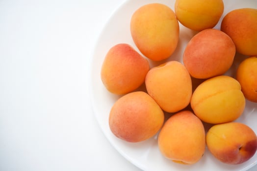 Yellow plums on a white plate. Fresh fruits. photo