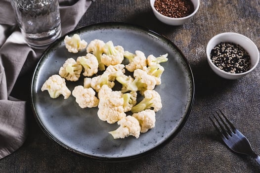 Vegetarian vegetable raw cauliflower on a plate on the table photo