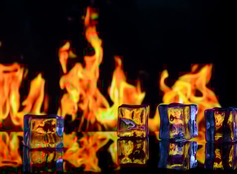 fire and ice cubes on a black background, place under the text photo