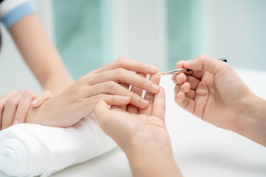 Woman receive care service by professional Beautician Manicure at spa centre. Nail beauty salon use nail file for Glazing treatment. manicurist make nail customer to beautiful. body care spa treatment photo