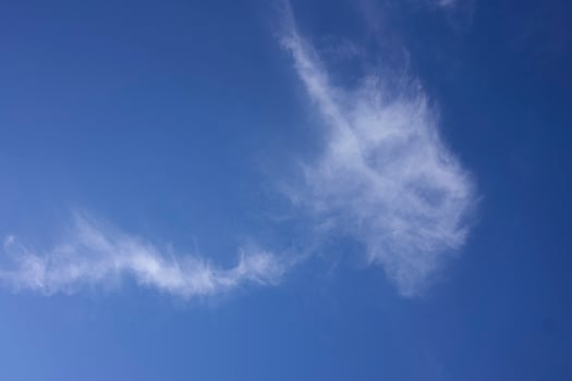 the sky on a summer day with white cirrus clouds photo