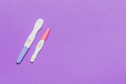 Colored Pregnancy test on colored background, top view with copy space photo