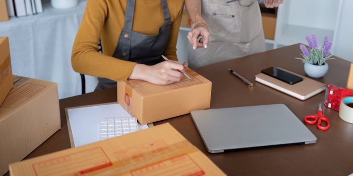 Friends Collaboration on Online Business, Packing and Shipping Products from Home Office photo