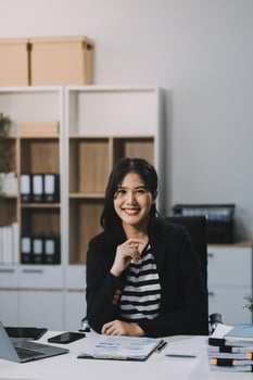 Young pretty business woman with notebook in the office photo