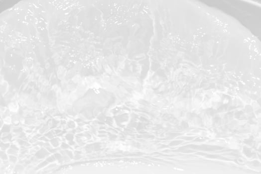 Blue water with ripples on the surface. Defocus blurred transparent blue colored clear calm water surface texture with splashes and bubbles. Water waves with shining pattern texture background. photo