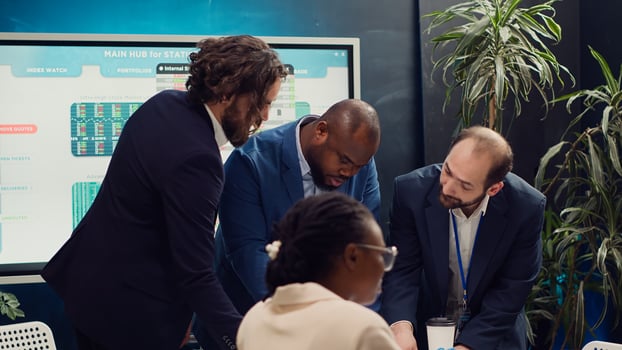 Business associates reviewing latest financial plans on documents, organizing a briefing meeting for sharing project updates and timelines to ensure progress. Coworkers making decisions. Camera A. photo