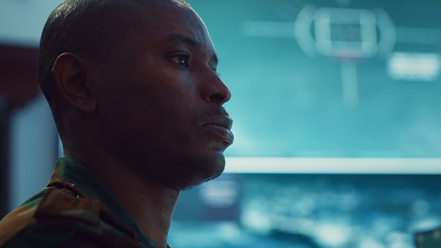 Lieutenant colonel gathering intelligence from federal radar systems, working with his crew in military command control room. Examining satellite imagery for reconnaissance mission. Camera A. photo