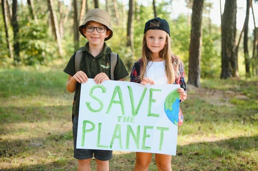 Children are holding a poster Save the planet. photo