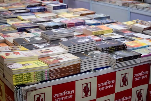 New Delhi, India, June 17 2024 - Variety of Books on shelf inside a book-stall at Delhi International Book Fair, Selection of books on display in Annual Book Fair at Bharat Mandapam complex photo