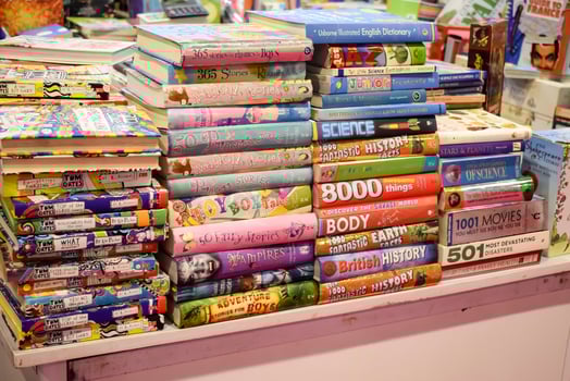 New Delhi, India, June 17 2024 - Variety of Books on shelf inside a book-stall at Delhi International Book Fair, Selection of books on display in Annual Book Fair at Bharat Mandapam complex photo