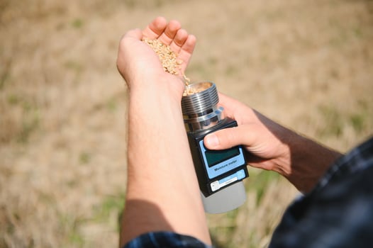 Young farmer in wheat field during harvest in summer photo