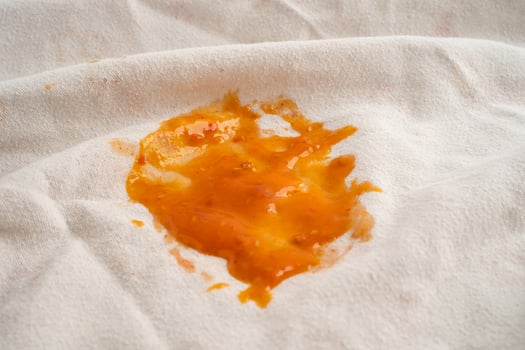 Dirty tomato sauce stain or ketchup on cloth to wash with washing powder, cleaning housework concept. photo