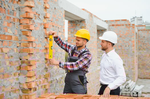 Builder and engineer on construction site photo