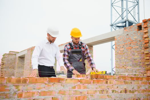 Builder and engineer on construction site photo