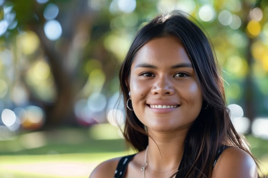 Young Woman Smiling In Sunlit Park photo