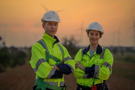 Team Engineers men and woman checking and inspecting on construction with sunset sky. people operation. Wind turbine for electrical of clean energy and environment. Industrial of sustainable. photo