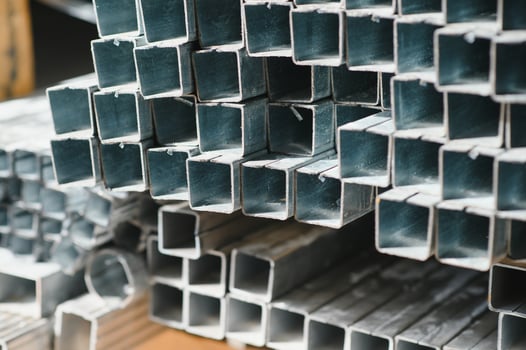 Aluminium profile for windows and doors manufacturing. Structural metal aluminium shapes. Aluminium profiles texture. Aluminium constructions factory photo