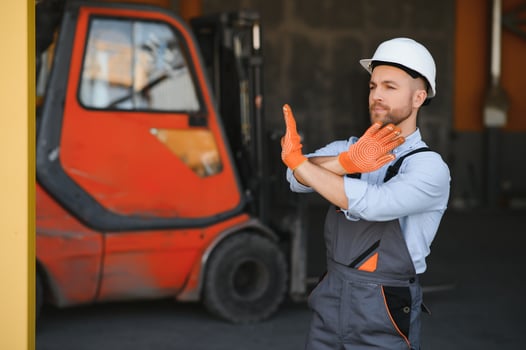 Man working at warehouse and driving forklift photo