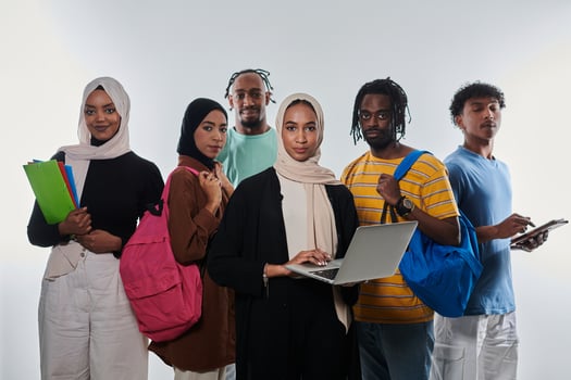 Group of diverse students engages in modern educational practices, utilizing a variety of technological tools such as laptops, tablets, and smartphones against a clean white background, exemplifying photo