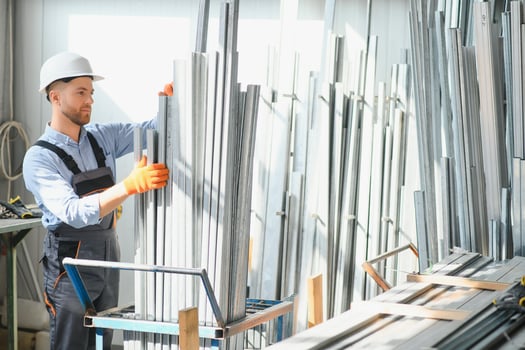 Factory worker measures the metal profile photo
