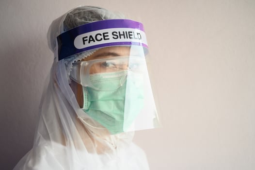 Nurse wearing PPE suit, Face shield and surgical mask for protect coronavirus disease. PPE while protecting healthcare workers from exposure to the COVID-19 virus in healthcare settings. photo