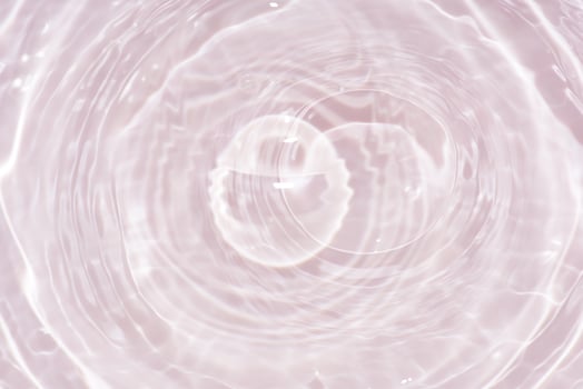 Blue water with ripples on the surface. Defocus blurred transparent blue colored clear calm water surface texture with splashes and bubbles. Water waves with shining pattern texture background. photo