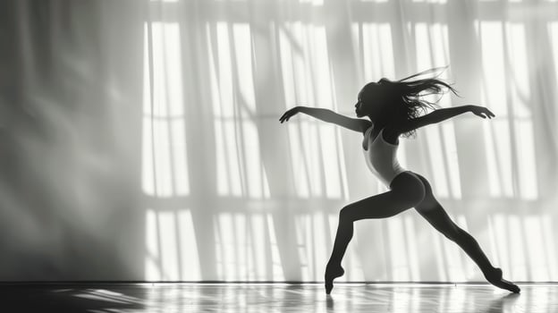 Young female dancer rehearses a dance routine in a well lit studio photo
