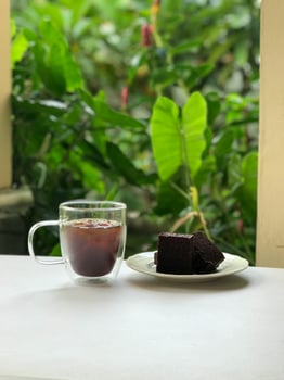 Iced Coffee and Chocolate Cake by Window. photo