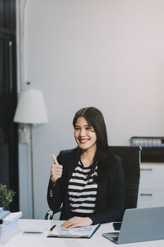 Young pretty business woman with notebook in the office photo
