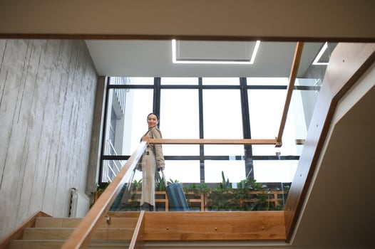 Businesswoman with suitcase on stairs in hotel photo