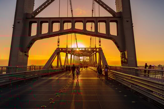 May 1, 2022. Florianopolis, Brazil. Hercilio luz cable bridge with walking people and sunset sky photo