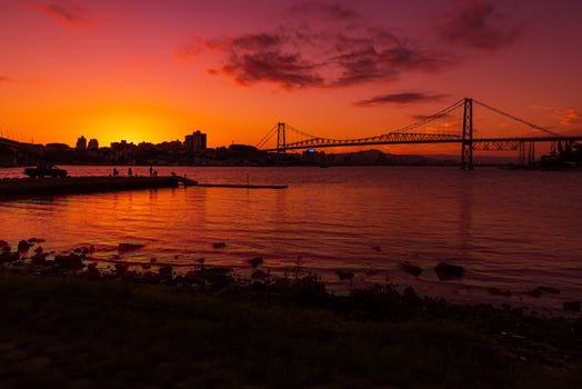 Hercilio luz cable bridge with sunset sky and reflection on water in Florianopolis, Brazil photo