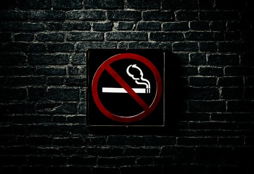 No Smoking Sign on a Dark Brick Wall photo