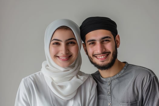 A young attractive hearty smile arab couple wearing while dress against isolated green color background photo