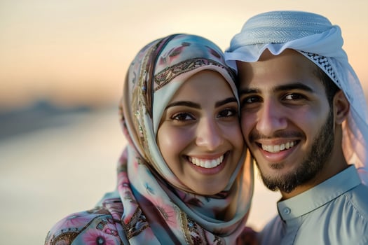 A Young Attractive Arabic Muslim Couple. Against The Beach See And Sunset Light photo
