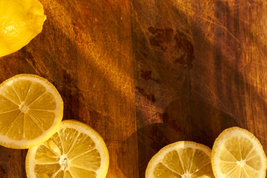 Slices of organic lemon on a wooden cutting board photo