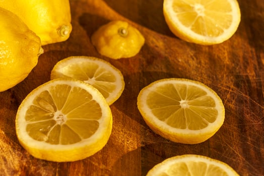 Slices of organic lemon on a wooden cutting board photo