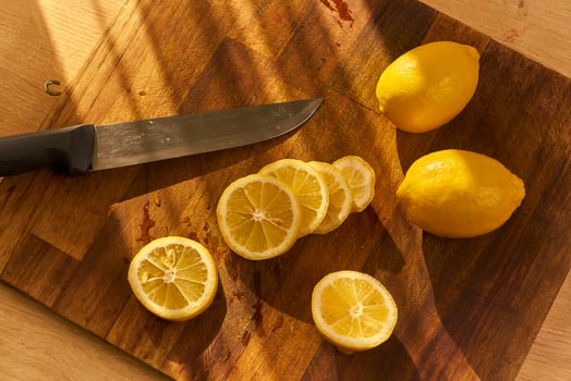 Slices of organic lemon on a wooden cutting board photo