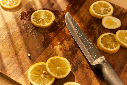 Slices of organic lemon on a wooden cutting board photo