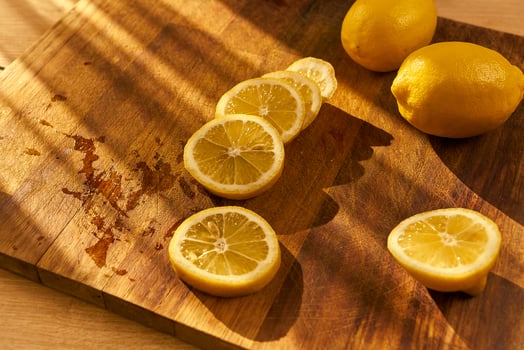 Slices of organic lemon on a wooden cutting board photo