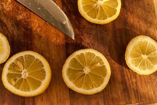 Slices of organic lemon on a wooden cutting board photo