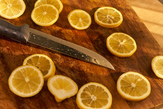 Slices of organic lemon on a wooden cutting board photo