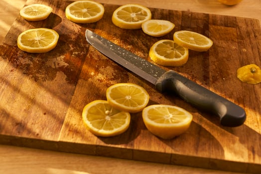 Slices of organic lemon on a wooden cutting board photo
